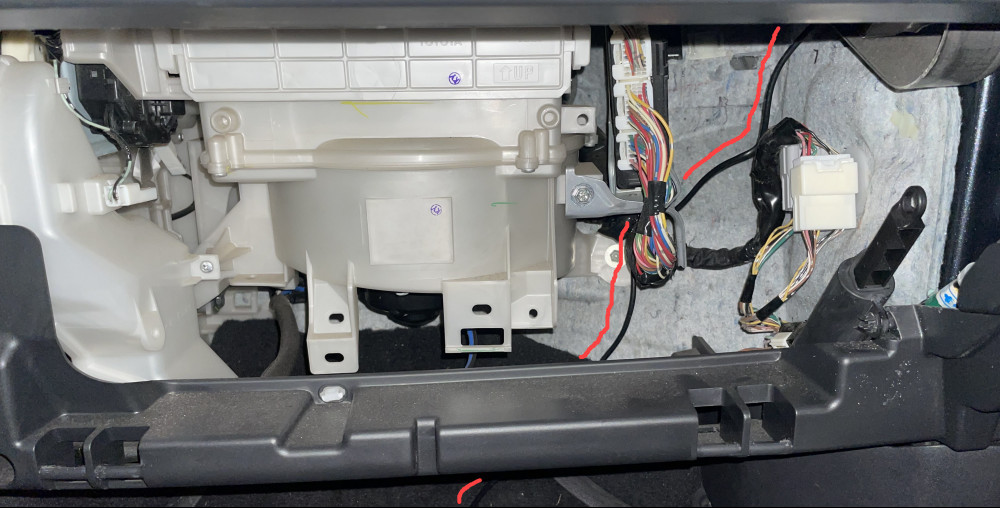 Picture showing the space behind a Scion tC glove box with a USB cable routed for a dash cam.