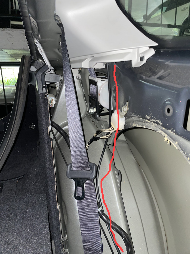 Rear dash cam cable routing along rear wheel well up behind c pillar trim.
