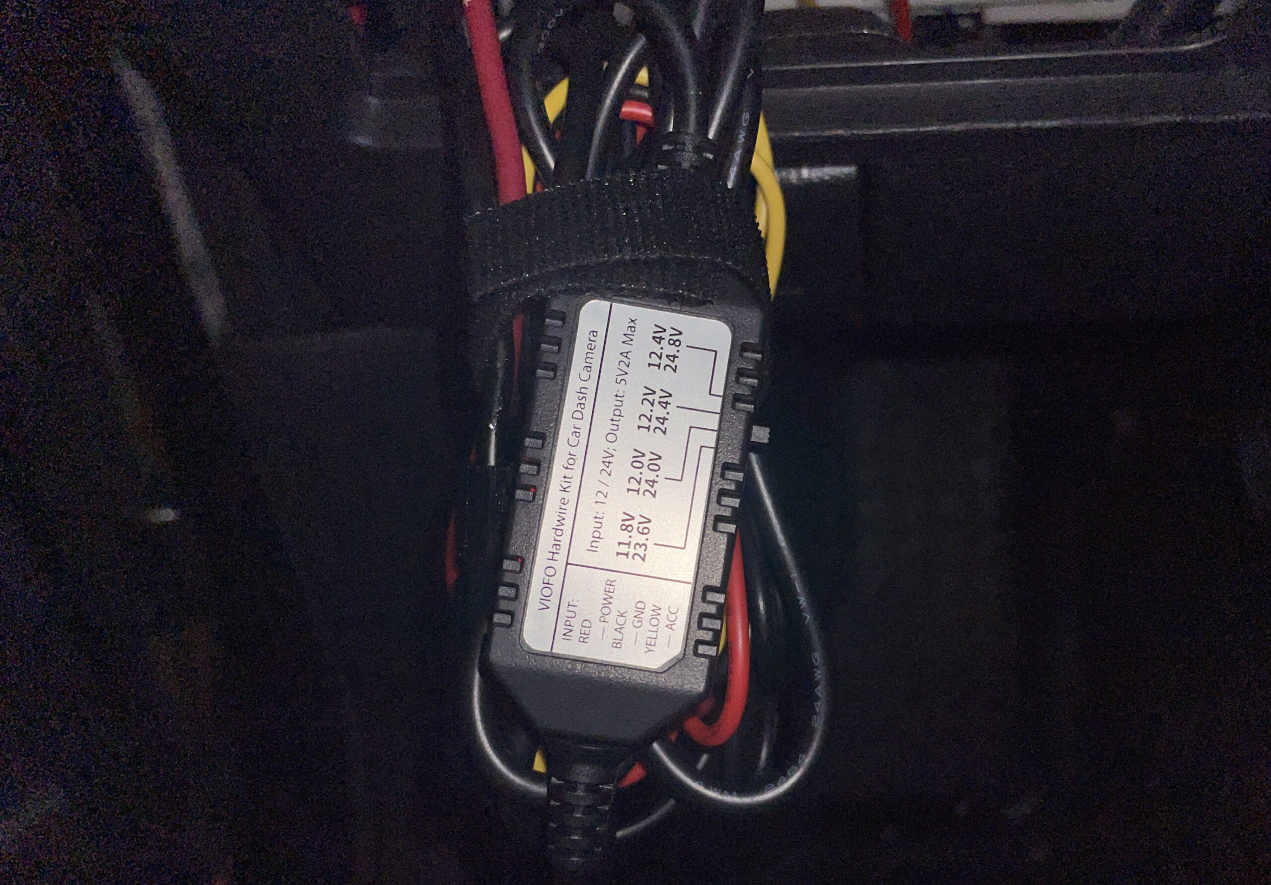 A picture of a Viofo hardwire kit set to 12.2V. The wires are bundled with velcro.